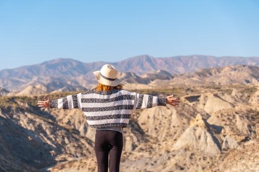 A young female Caucasian hiker enjoying freedom at the Tabernas desert in Almeria, Andalusia, Spain