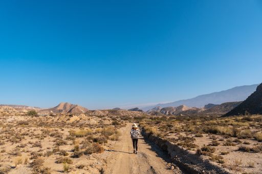 A female hiker on the Colas de Dragon trail in the desert of Tabernas, Almeria province, Andalusia
