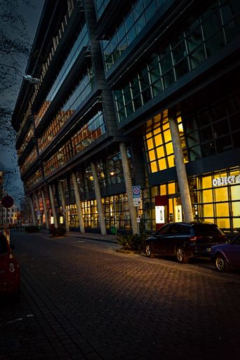 The illuminated shops lighting a street at Dusseldorf city in Germany at night