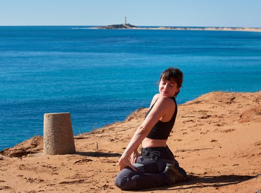 A closeup of a girl doing a yoga on the beach