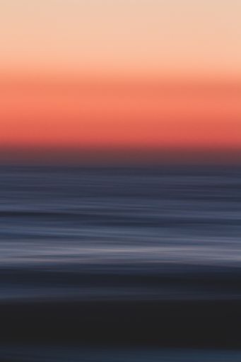 A breathtaking shot of the reflection of a colorful sunset with long exposure effect