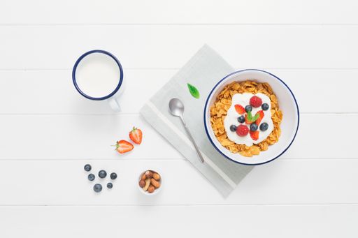 A closeup shot of muesli in a bowl on a white background