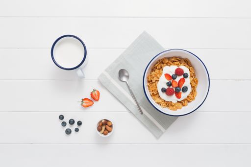 A closeup shot of muesli in a bowl on a white background