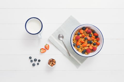 A closeup shot of muesli in a bowl on a white background