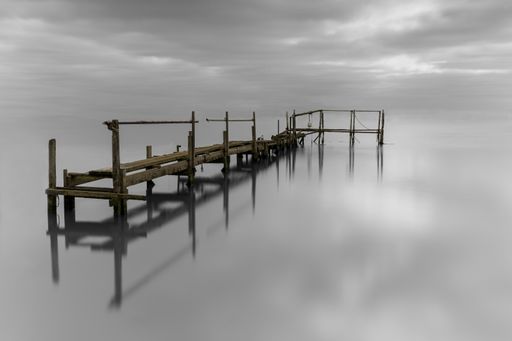 A beautiful shot of an abandoned jetty under the cloudy skies in Essex