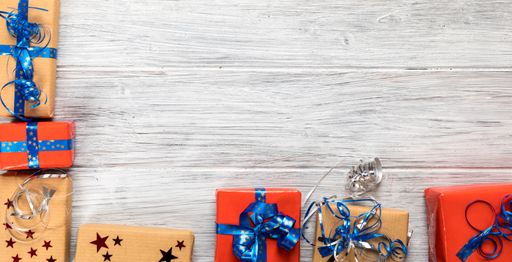 A closeup shot of Christmas presents  on a wooden surface with space for text