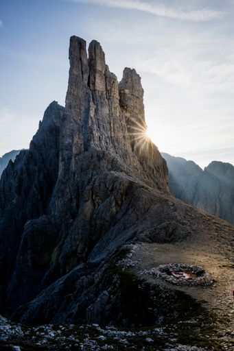 A vertical shot of a fireplace on the mountain with a blue sky in the background