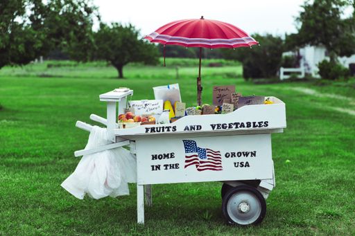 A farm stand selling goods in a park