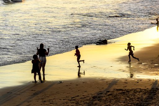 A silhouette of tourists having fun on the Ondina beach in Salvador city, Bahia in Brazil