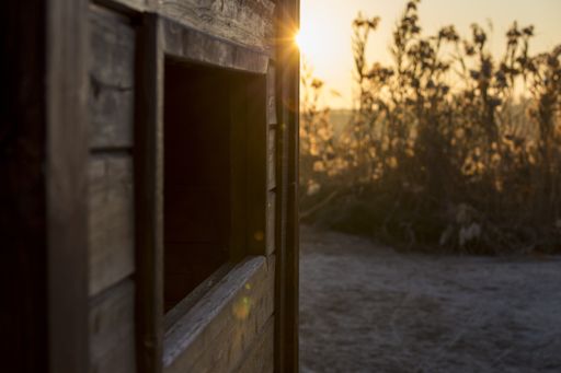 A closeup shot of a wooden country house during a sunset