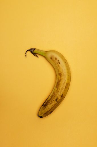 A top view of a banana over yellow background