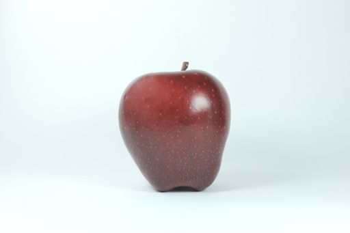 A closeup of a red apple on white background