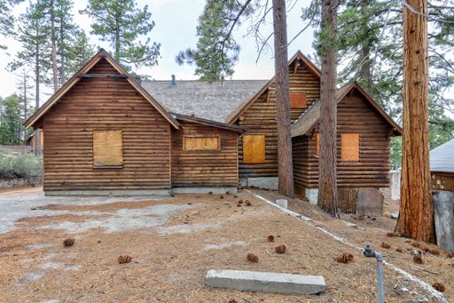 A collection of abandoned cabins that once made up the Round Hill Pines Resort at the edge of Lake Tahoe sit boarded up, a hidden scene amidst the lak