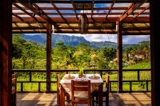 A beautiful shot of a table on a balcony over the rice fields of Bali, Indonesia