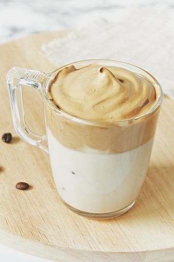 A closeup shot of iced Dalgona whipped coffee with fluffy creamy