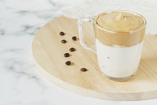 A closeup shot of iced Dalgona whipped coffee with fluffy creamy