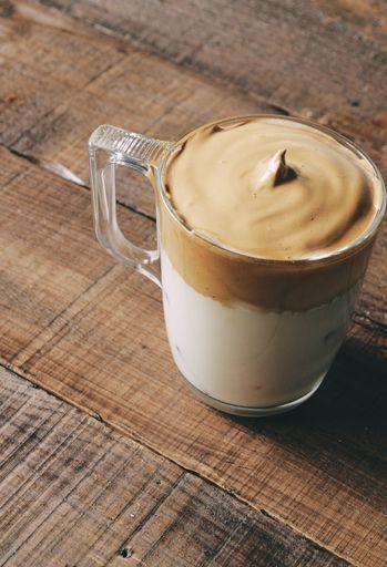 A closeup shot of iced Dalgona Coffee, fluffy creamy whipped coffee.