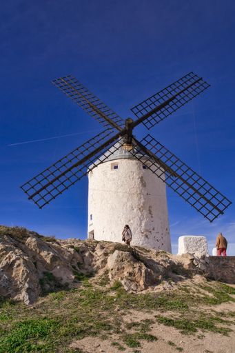 An old historical windmill in Consuegra against a blue sky on a sunny day