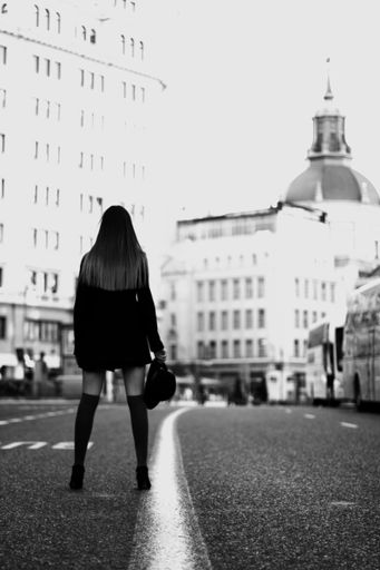 A beautiful shot of a Caucasian woman posing for a photo in Germany - grayscale