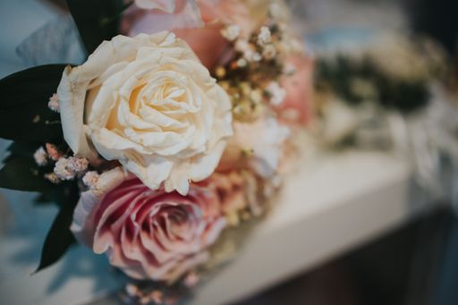 A Closeup of wedding bouquet of white and pink roses