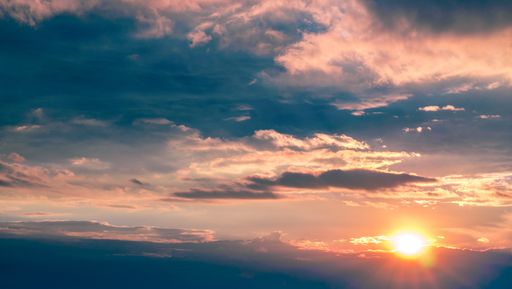 A beautiful wide shot of a pinkish sky with clouds during sunset