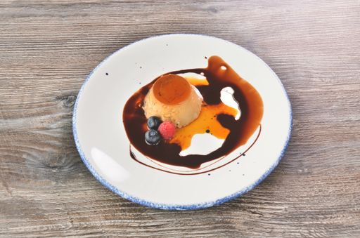 A closeup shot of a cheesecake on the wooden table
