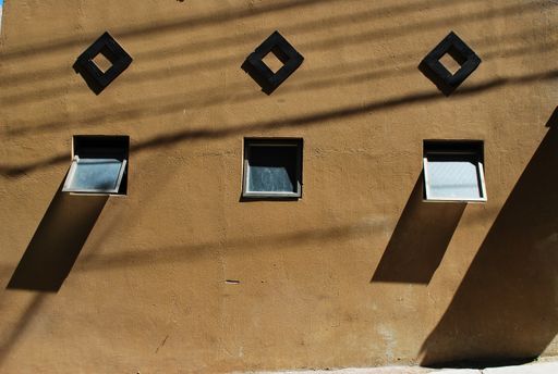 A beautiful closeup of square symmetric windows under the sunlight