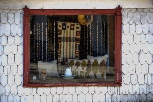A closeup shot of a house facade and window with woven crafts