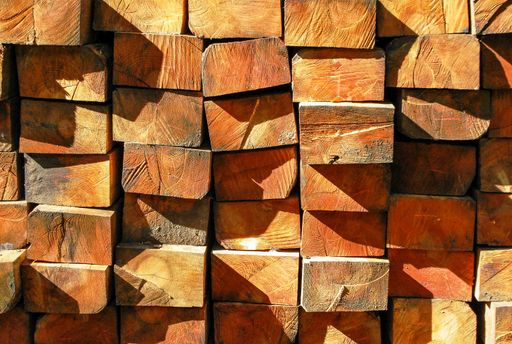 A closeup picture of wooden pieces on each other under the sunlight