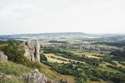 A high angle shot of a village on the beautiful fields under the bright sky