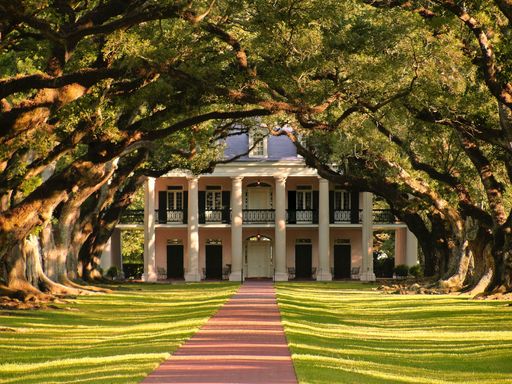 Oak Alley Plantation manor house  tree lined pathway at twilight