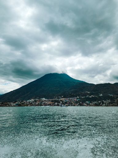 The beautiful vertical shot of the view of San Pedro volcano and San Pedro city, Lake Atitlan, Guatemala.