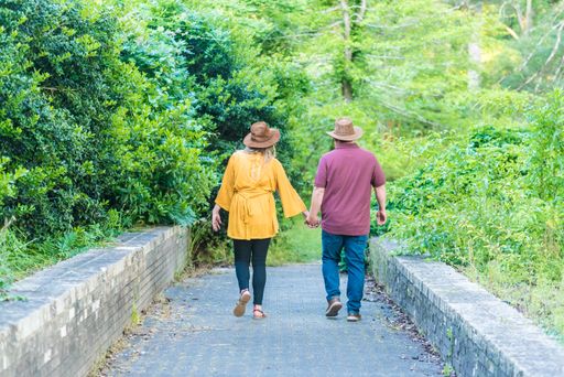 A beautiful shot of a couple walking  in the park