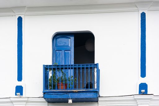 A closeup of a beautiful blue balcony with a plant at daytime