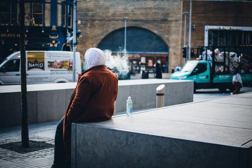 A shallow focus candid of a person taking a break looking at a busy street