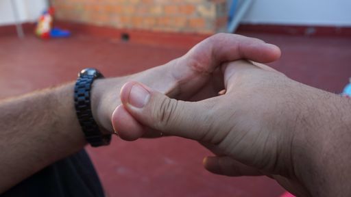 A man doing a hole with his fingers with blurred background