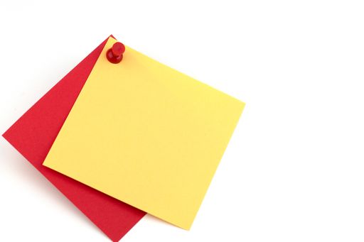 A closeup shot of red and yellow stickers on a white background