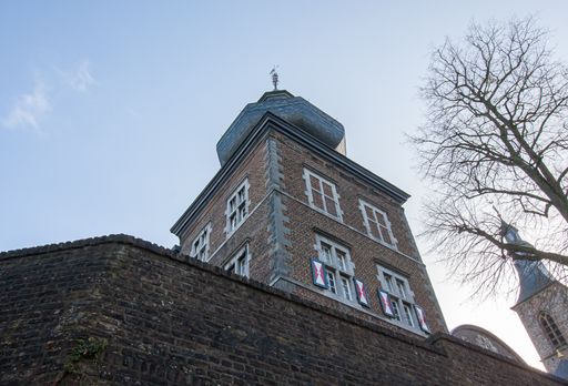 A vertical shot of Rolduc building tower against a blue sky in  Kerkrade, Netherlands