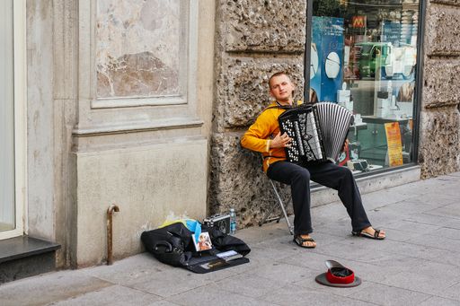 MILAN, ITALY - SEPTEMBER, 24, 2009: A young man is playing his accordion on a street in Milan, Italy.