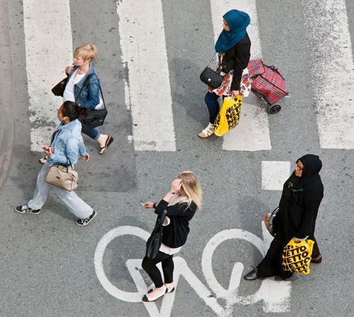 A view of women from different nationalities crossing the street -integration and immigration concept