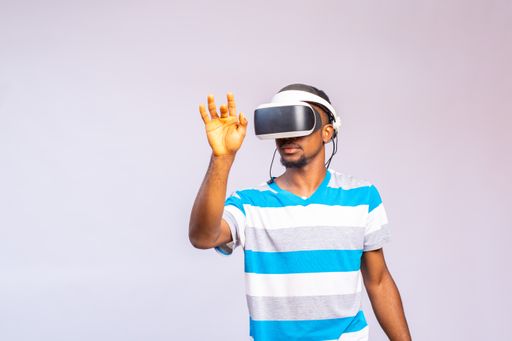 A handsome African man using VR glasses. Virtual reality experience.