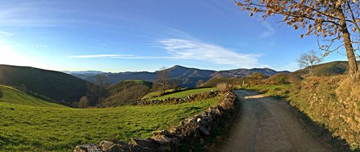 A panoramic shot of a beautiful valley on  an autumnal sunny afternoon