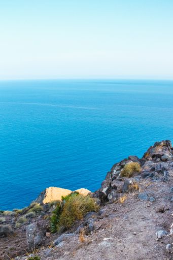 A vertical shot of a cliff and a blue sky