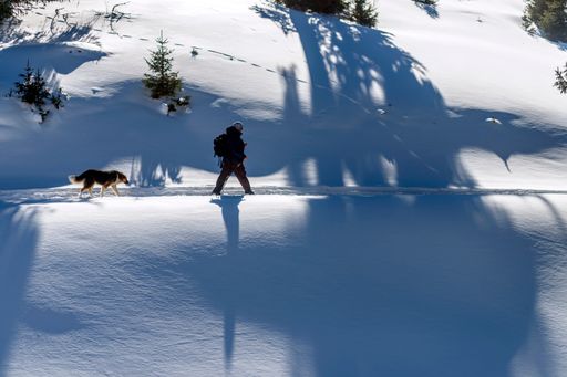A closeup of a person walking on a snowy mountain
