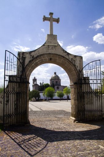 A beautiful shot of an opened gate  leading to an entrance of the church
