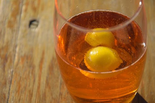 A closeup shot of lemon slices in a glass of beer on a wooden table