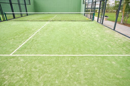 A high angle shot of a green padel court