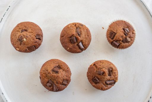 A top view of the homemade chocolate muffins just taken from the oven on the white plate