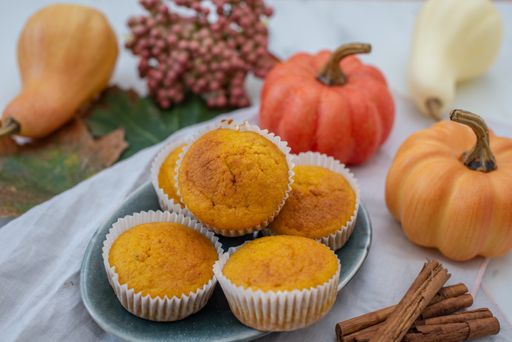 A closeup shot of the homemade pumpkin muffins just taken from the oven with the decorations of pumpkins