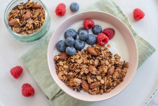 A healthy breakfast with a bowl of granola, yogurt and fresh berries